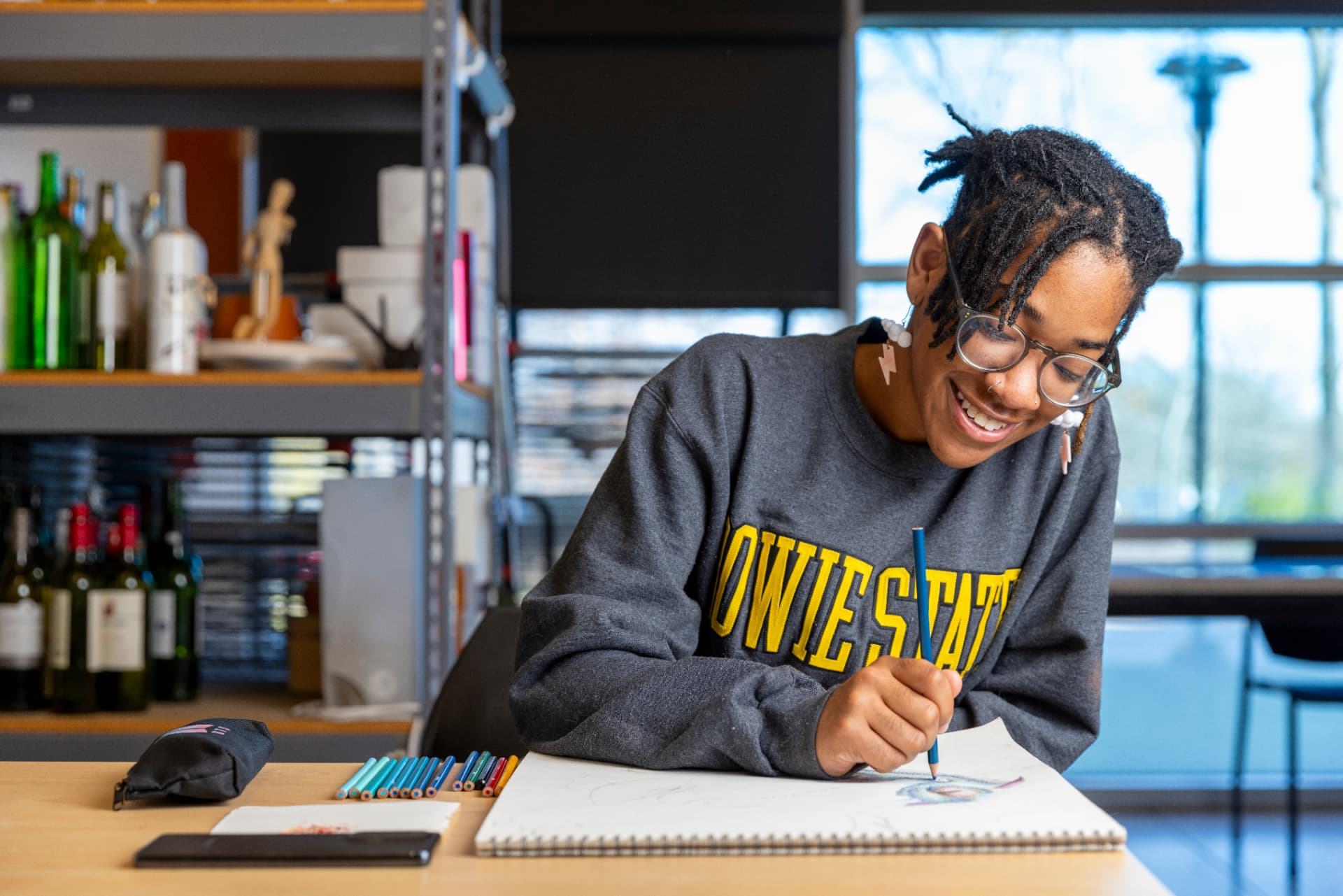 A Bowie State student sketching in a design studio